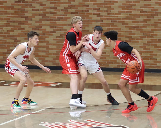 Loving's Bobby Parraz (right) attempts an offensive thrust against New Mexico Military Institute during a Jan. 27, 2024 basketball game in Roswell.