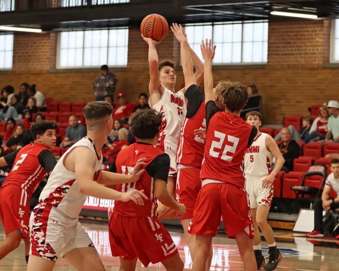 New Mexico Military Institute junior forward Cole Seidenberger shoots against multiple Loving defenders during a Jan. 27, 2024 game in Roswell.