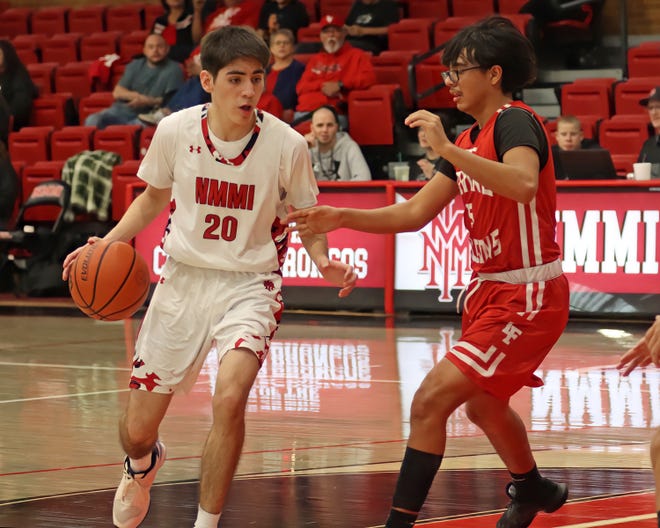 New Mexico Military's Lorenzo Peral goes against Loving's Kysiah Lujan during a Jan. 27, 2024 game in Roswell. Loving won the contest.