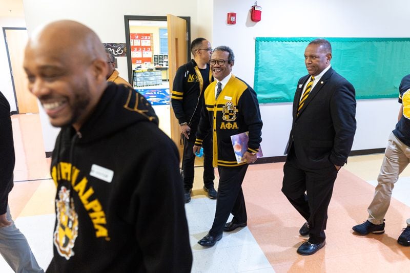 Members of Alpha Phi Alpha Fraternity's Omicron Phi Lambda chapter based in East Point prepare to read to students at Asa G. Hilliard Elementary School in East Point on Wednesday, March 27, 2024. (Arvin Temkar / arvin.temkar@ajc.com)